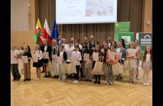 Zdjęcie wspólne uczestników konkursu (starsza grupa) z osobami przekazującymi nagrody w sali Urzędu